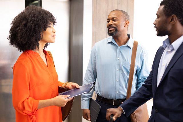 Diverse Businesspeople Discussing in Office Hallway - Download Free Stock Images Pikwizard.com