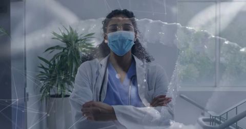 Medical Professional with Digital Network in Hospital Corridor