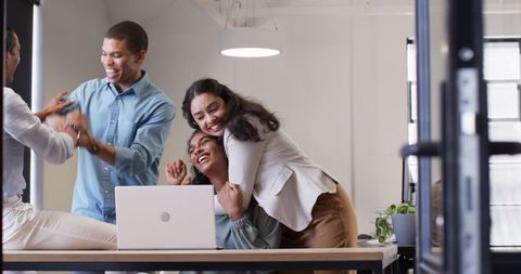 Team Celebrating Success in Office Meeting