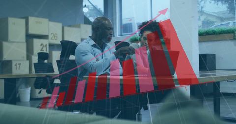 Diverse business team reviewing growth graph in modern office