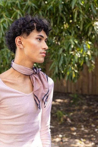 Young man embracing bohemian style in natural setting