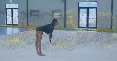 Gymnastics Elegance Enhanced by Golden Dust Artistry