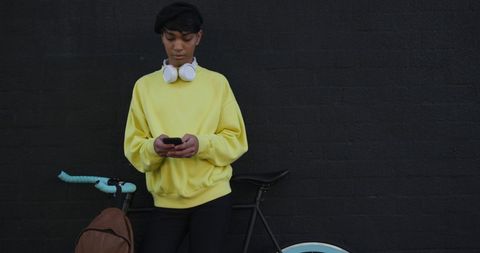 Modern Man in Yellow Sweater Using Smartphone by Bike - Download Free Stock Images Pikwizard.com