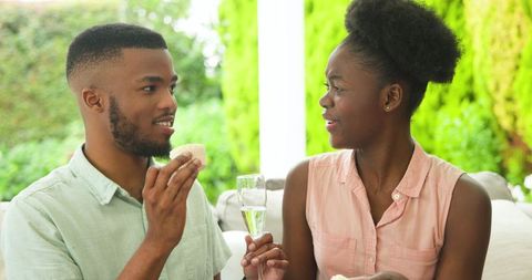 Young Couple Relaxing with Champagne on Outdoor Patio
