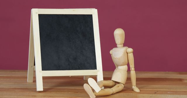 Wooden Mannequin Figure Sitting by Chalkboard Easel - Download Free Stock Images Pikwizard.com