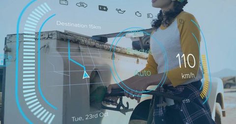Woman refueling pickup with augmented reality hud showing navigation, speed and fuel data
