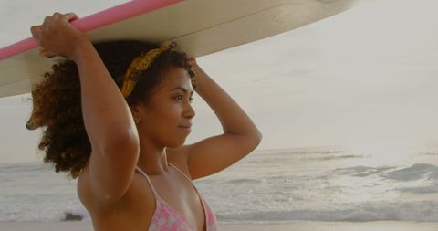 Confident Female Surfer Holding Board at Scenic Beach - Download Free Stock Images Pikwizard.com