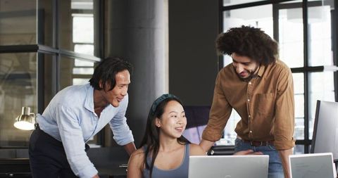 Diverse Team Collaborating Cheerfully at Office Desk