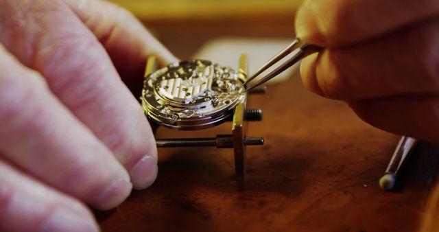 Close-up of Watchmaker Repairing Watch Mechanism with Tweezers on Workbench - Download Free Stock Images Pikwizard.com