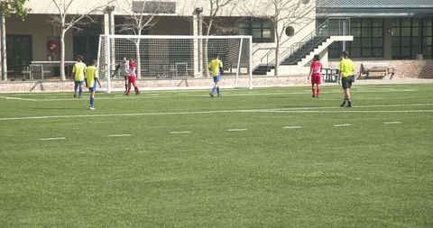 Soccer practice session on field with athlete in yellow jersey