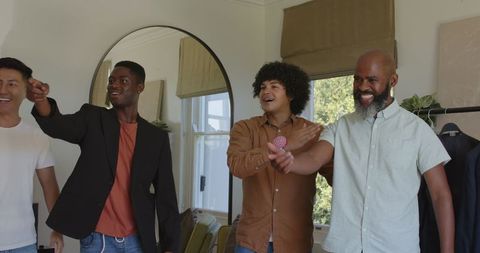 Groomsmen supporting groom with laughter and tie adjustment