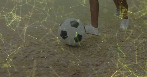 Schoolgirls Playing Football on Field with Digital Network Overlay