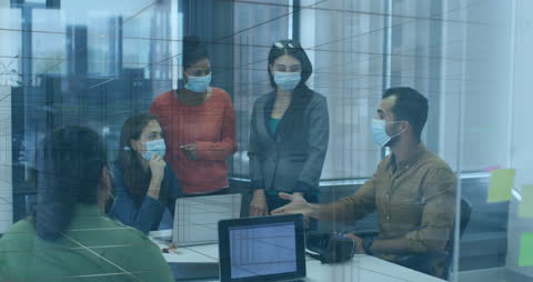 Business Colleagues Collaborating with Laptops and Masks in Office