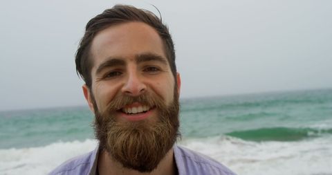 Smiling Bearded Man Enjoying Ocean Breeze at Beach - Download Free Stock Images Pikwizard.com