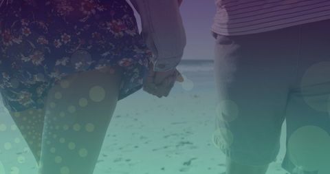 Romantic Caucasian Couple Holding Hands on Beach Walk