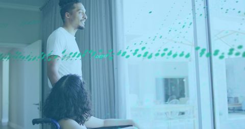 Diverse Couple Analyzing Digital Graphs Together Indoors