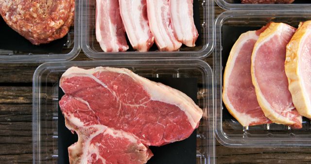 Assorted Raw Meat Cuts on Wooden Table - Download Free Stock Images Pikwizard.com