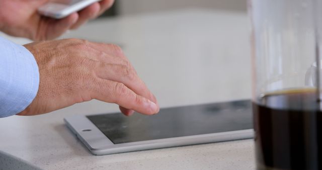 Man Using Tablet Computer in Office with Coffee Cup - Download Free Stock Images Pikwizard.com