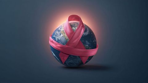 Earth wrapped by pink awareness ribbon for global health advocacy