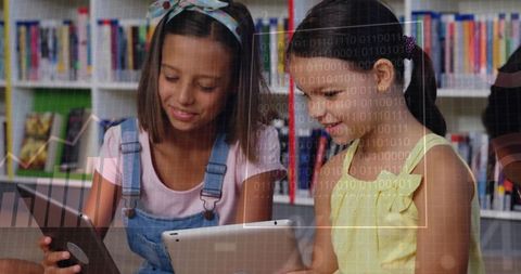 Girls Using Tablets in School Library with Binary Overlay Illustrating Digital Learning