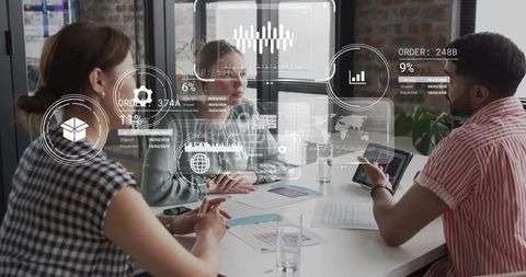Business team reviewing AR analytics and supply chain metrics in modern glass boardroom
