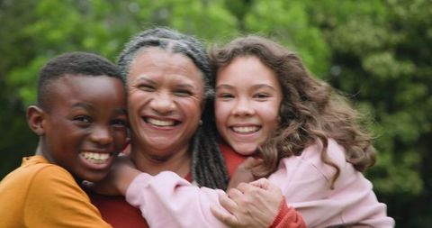 Loving family embracing outdoors in garden setting