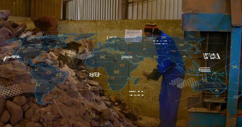 Worker Loading Rocks into Machine with Global Map Technology Overlay