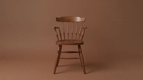 Vintage wooden armchair on brown seamless background