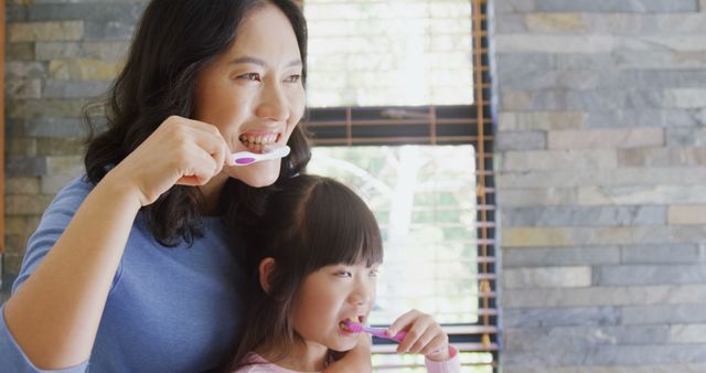 Mother and Daughter Brushing Teeth Together in Cozy Bathroom - Download Free Stock Images Pikwizard.com