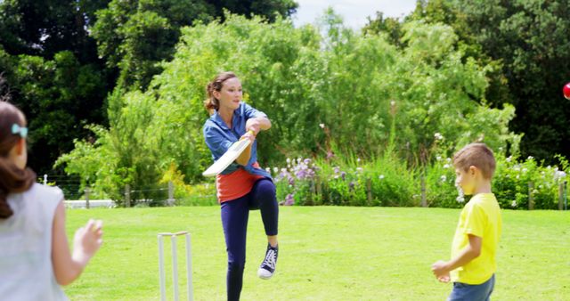 Young Woman Playing Cricket with Children in Sunny Park with Copy Space - Download Free Stock Images Pikwizard.com