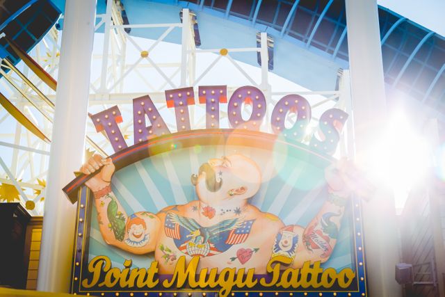 Colorful Point Mugu Tattoo Sign at Amusement Park in Sunlight - Download Free Stock Photos Pikwizard.com