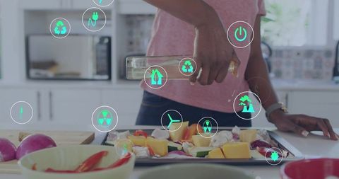Pouring oil coating baking tray preparing roasted vegetables with smart kitchen ar icons