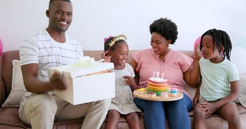 Joyful Family Birthday Celebration with Cake and Gift Present