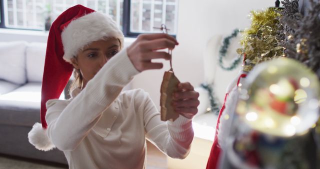 Young Woman Decorating Christmas Tree with Ornaments - Download Free Stock Images Pikwizard.com