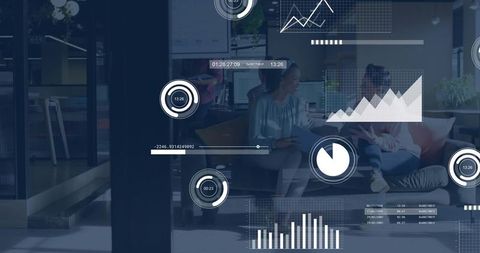Businesswomen collaborating with data overlays in modern office lounge analyzing charts
