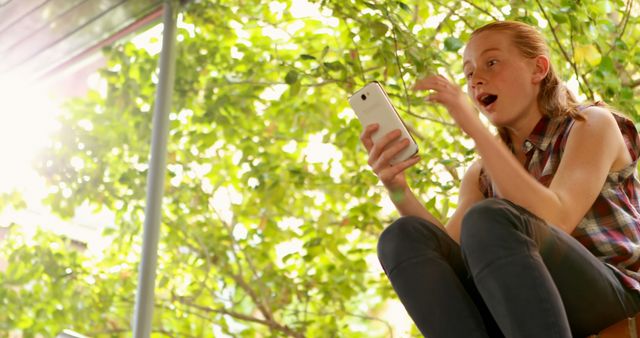 Excited Teen Girl Using Smartphone Outdoors Under Sunlight - Download Free Stock Images Pikwizard.com