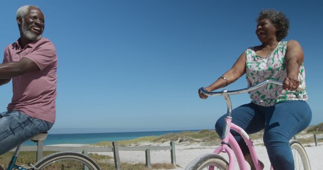Senior Couple Enjoying Bike Ride on Sunny Beach - Download Free Stock Images Pikwizard.com