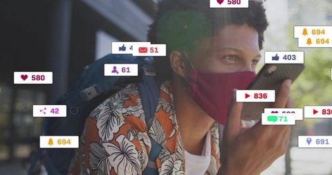 Speaking into smartphone wearing maroon mask while getting social media notifications