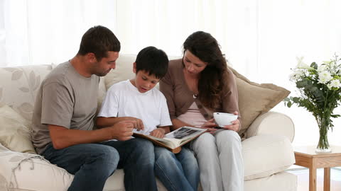 Happy Family Reading Together on Modern Couch