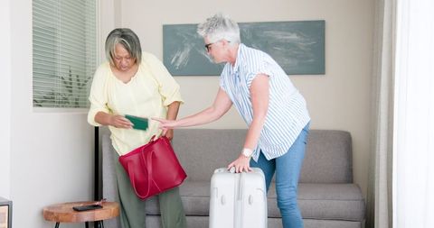 Senior Couple Preparing Luggage for Travel Adventure