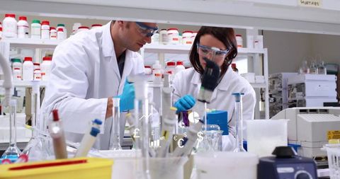 Scientists conducting research in modern laboratory with precision