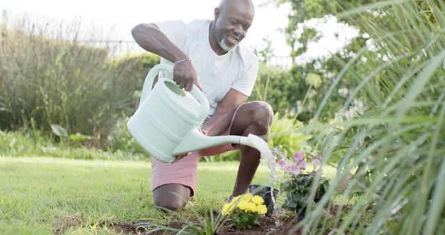 Happy Senior Man Watering Plants in Garden for Relaxation - Download Free Stock Images Pikwizard.com