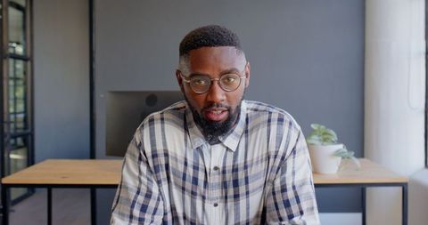 Confident Business Professional Explaining Project in Modern Office