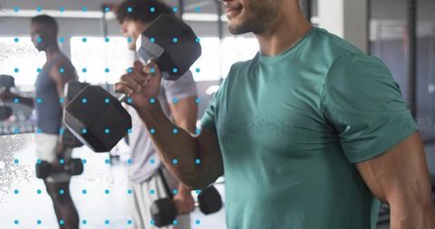 Men Strength Training with Dumbbells in Modern Gym