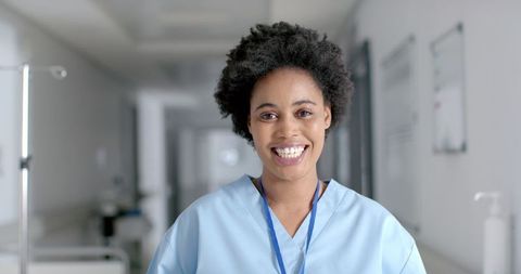 Smiling African American Nurse in Hospital Corridor