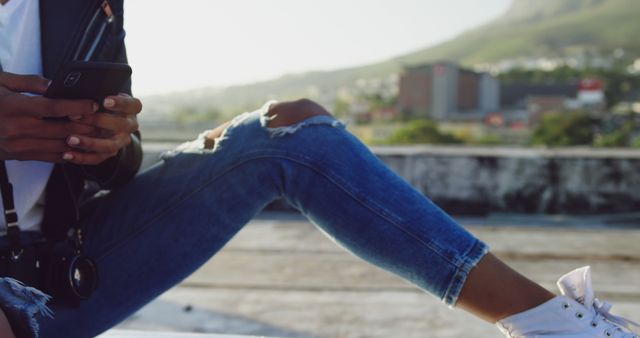 Young Woman Taking Photos on Rooftop in Jeans - Download Free Stock Images Pikwizard.com