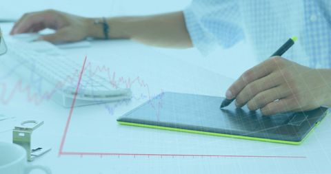 Businessman Analyzing Data on Graphics Tablet with Graph Overlays - Download Free Stock Images Pikwizard.com