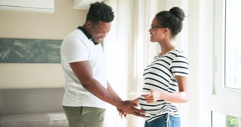 Excited Couple Experiencing Joy of Pregnancy Together at Home
