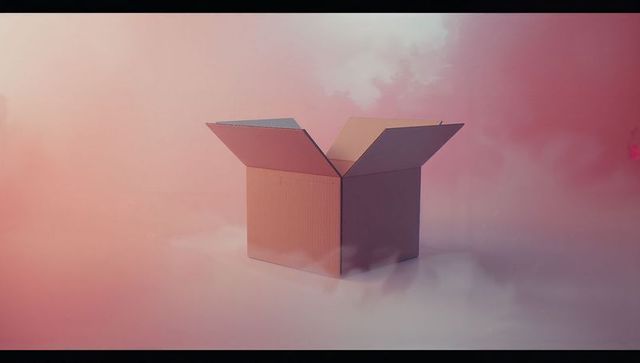 Cardboard box floating in mystical pastel atmosphere