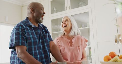 Happy Senior Couple Laughing Together in Bright Kitchen - Download Free Stock Images Pikwizard.com